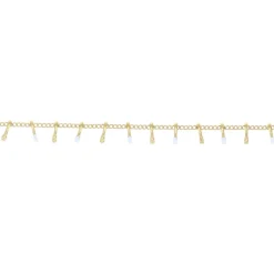 Bracelet doré et gouttes blanches